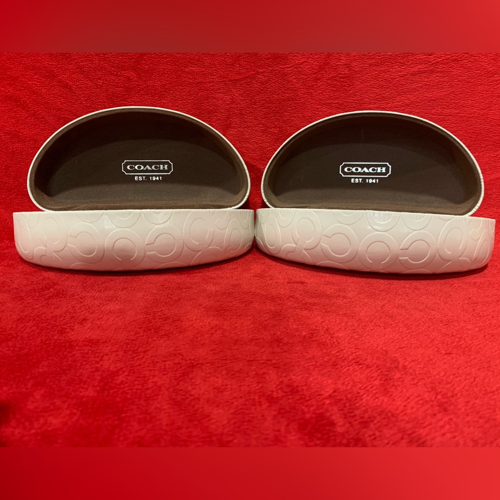 Coach sunglass cases. Cream embossed with Coach logo and brown lining.